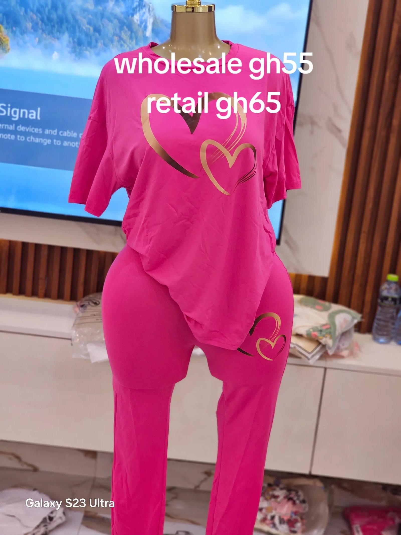 Golden Heart Monochrome Set - Hot pink oversized short-sleeve tee and matching slim-fit high-waisted trousers with metallic gold double-heart outline graphics on chest and upper left leg