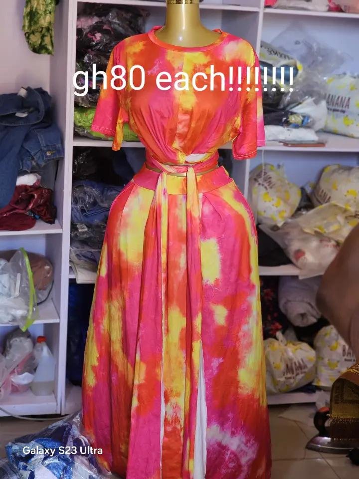 Solaris Tie-Dye Maxi Set - Short-sleeve wrap top with long waist ties and high-waisted floor-length maxi skirt in vibrant sunset gradient featuring hot pink, fiery orange, and bright yellow tie-dye pattern